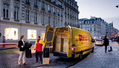 DHL courier with delivery van in streets of Paris